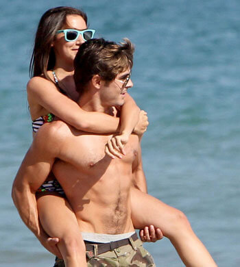 Zac Efron and Ashley Tisdale play around on the beach during Ashley’s 26th birthday party in Malibu