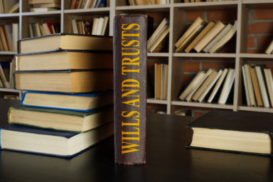 Law book about wills and trusts on the desk.