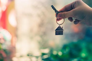 House model and key in home insurance broker agent  hand or in salesman person. Real estate agent offer house, property insurance and security, affordable housing concepts