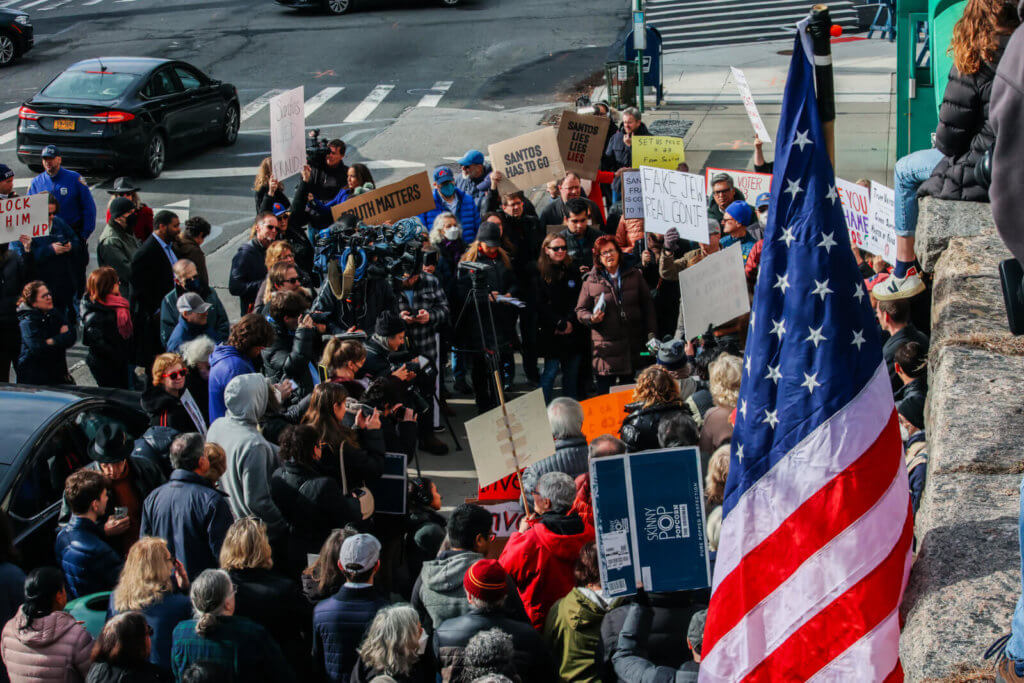  Several dozen community members and leaders gathered outside the New York Congressional District 3 office in Douglaston on Saturday, Jan. 7, to protest against Congressman George Santos. (Photo by Adrian Childress)