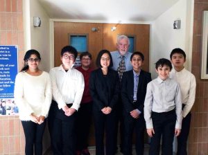 Math teacher Paul McNamara congratulates the school’s participants in the Long Island Math Fair Nassau County preliminary round. 
