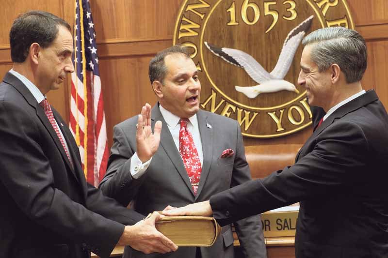 While Town of Oyster Bay Clerk James Altadonna Jr. (left) holds the town’s historic Bible, Supervisor Joseph Saladino (center) swears in Joseph Nocella as the new town attorney at the Feb. 14 town board meeting. (Photo by Frank Rizzo)