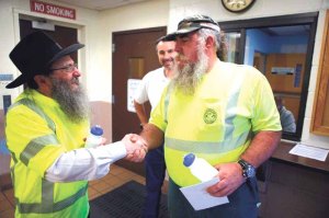 Rabbi Anchelle Perl (left) visited workers from the Town of Oyster Bay Sanitary Collection Services Division to express his gratitude for their hard work. 