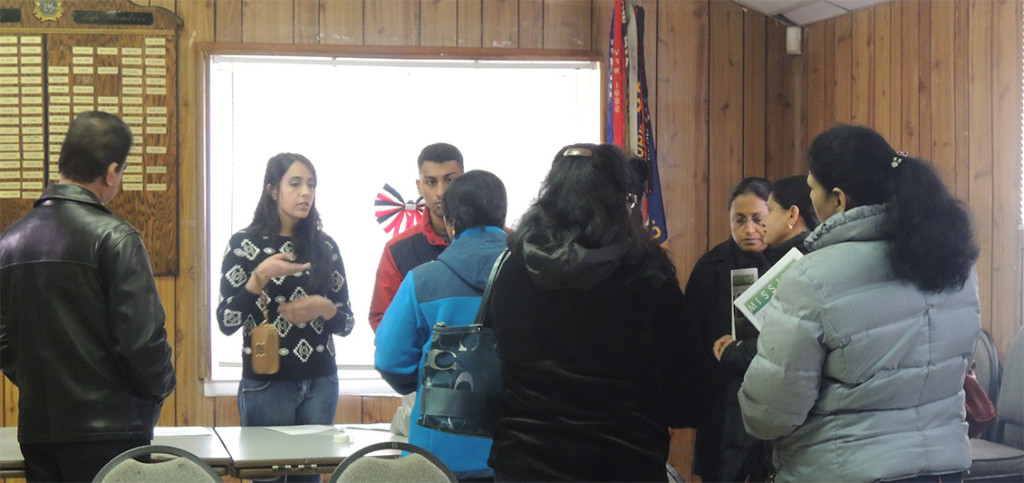 Jasmine Joseph's family hands out fliers to volunteers at the VFW in Syosset Tues., March 4.
