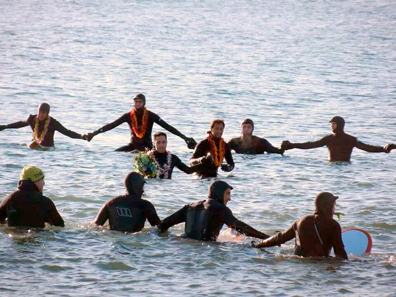 Zorbo’s sons Justin and Chris in the center of the circle wearing Hawaiian leis while they recited The Lord’s Prayer.