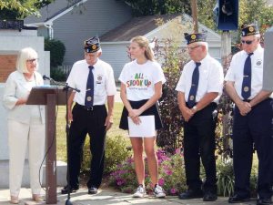 Supervisor Judi Bosworth gives remarks at the Sept. 11 ceremony. With her are Post Commander Al Piscitelli and Carle Place student Jean-Marie Neaves, as well as members of the Post.