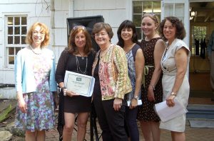Eileen Shea Neville (second from left) accepts the Terri Shkuda award from (left to right) Diane Bares, executive director of The Art Guild; Kathy Shkuda; Shelley Holtzman, co-president of The Art Guild; Delia DeRiggi-Whitton, county legislator; and Ilene Silberstein, co-president of The Art Guild, at The Art Guild’s 2015 Members Showcase Garden Party Reception (Photo Credit: Susan Herbst)