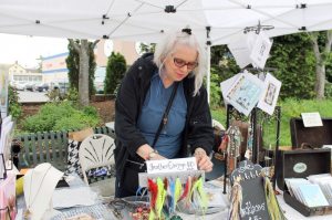 Jewelry maker and co-recording secretary Maureen Baranov sets up her display of finely crafted jewelry