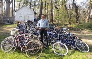Steve Finkelstein amidst the 250 bikes the school has already collected. Their goal is 500.
