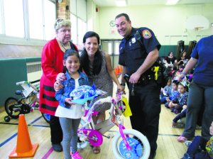 Amanda Romero (center) with Principal Dale Telmer, teacher Solange Hernandez and officer Todd Aiken. 