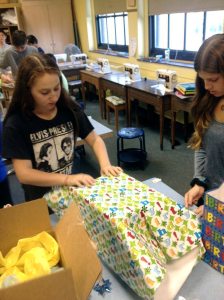 Weber MS students wrap gifts for their Birthday in a Box project. (Photo courtesy of the Port Washington Union Free School District)