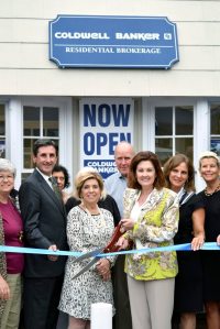 North Hempstead Town Clerk Wayne Wink, Coldwell Banker Residential Brokerage Port Washington Office Manager Gracene Gardella, President Laura Rittenberg and Executive Vice President of Northeast and Eastern Seaboard Regions of NRT LLC Maureen Passerini, along with affiliated sales associates in front of the new Port Washington office.