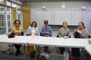 Carol Parker, Mimi Scrandis, JoAnn Moreno, Eleanor Nargentino and Wendy Soto enjoy some knitting. 