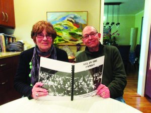 Nancy and Stan Turetsky with their family cookbook. On the cover is a photo taken at a family gathering in the early 1950s.