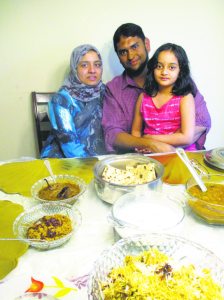 Rubina Rafi and Azhar Bhatt with their eldest daughter Zaara with a meal of Hyderbadian specialties.
