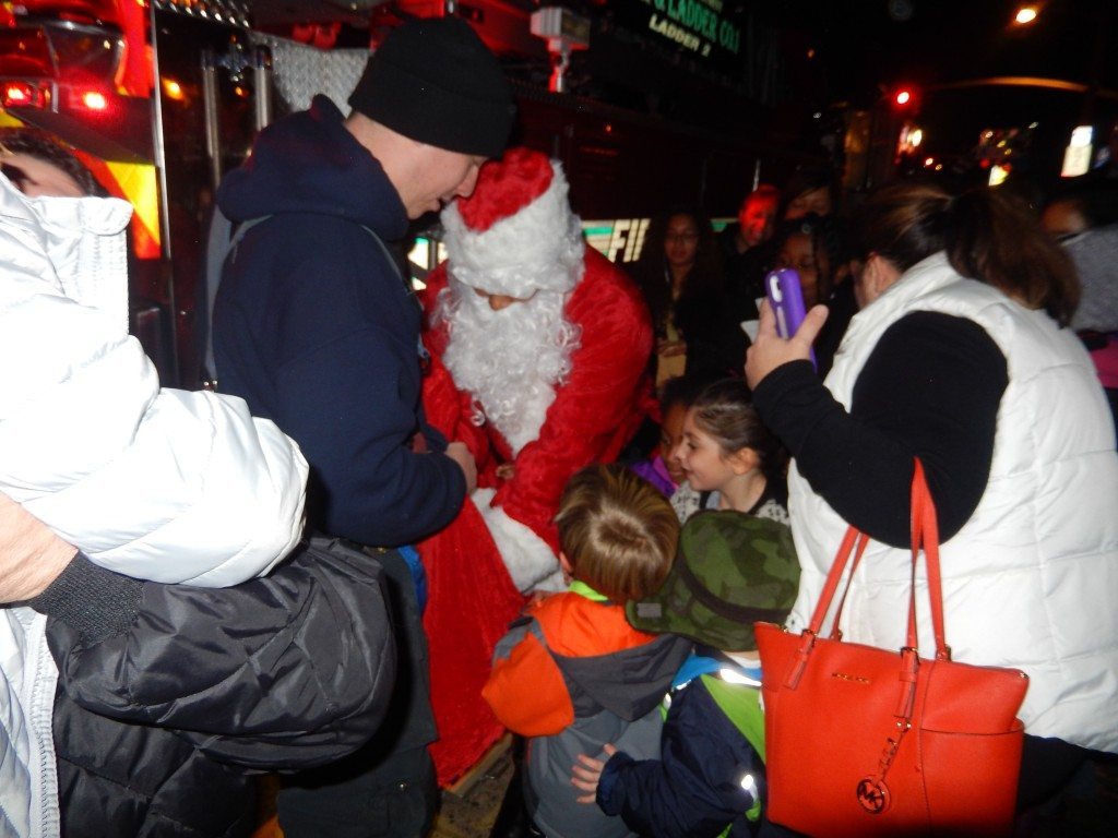 Children mobbed Santa to say hello and get a candy cane
