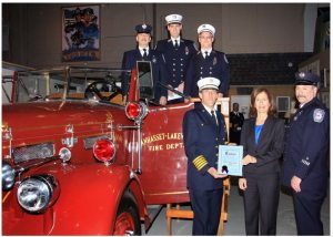 Legislator Ellen W. Birnbaum with members of the Manhasset-Lakeville Fire Department including Chief Mark Kiess