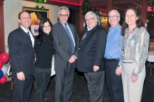 Michael Koblenz, third from right, congratulates fellow East Hills board members