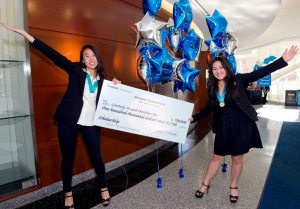 Christine Yoo and Kimberly Te hold their $100,000 scholarship check for winning the Siemens Competition.