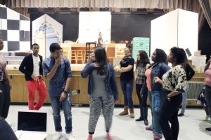 Teens practice the song "You're The One That I Want." 