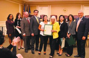 XXXXX (center) was recently recognized by the Town of North Hempstead board.