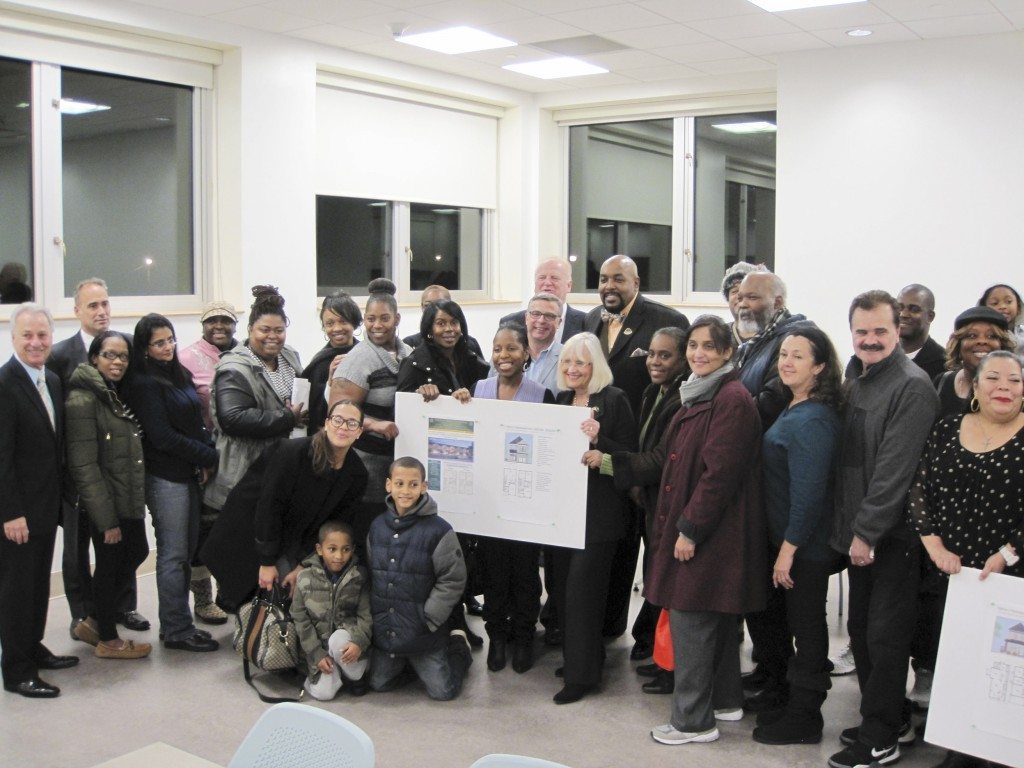 Town and community leaders with winners of the housing lotto