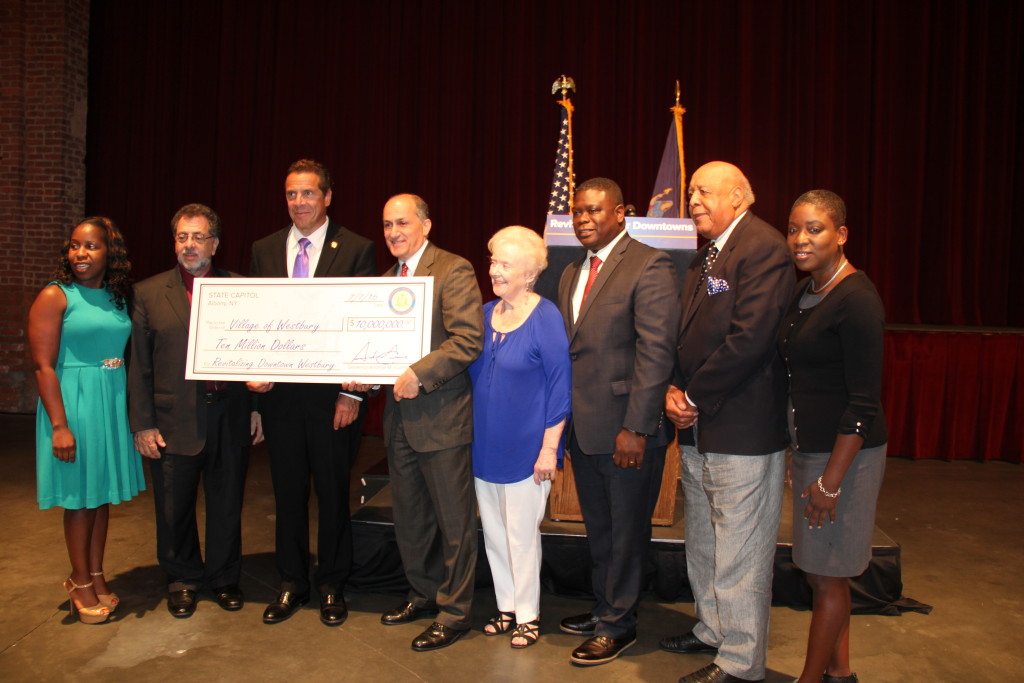 Gov. Andrew Cuomo (third from left) presented a $10 million check to Village Mayor Peter Cavallaro (fourth from left). Also pictured (from left) are Councilwoman Viviana Russell, trustees Steven Corte, Joan Boes, Beaumont Jefferson and William Wise, and Nassau County Legislator Siela Bynoe