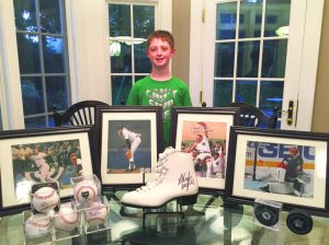 Ian Myer with his collection of sports memorabilia that he will be auctioning. 