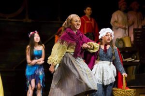 Cinderella, played by freshman Dani Drucker, and Little Red Riding Hood, played by freshman Haylie Lempert, skip into their first high school musical, along with ensemble members Pinocchio and The Three Little Pigs in the background. (Photos by Anthony Sokolov and Katelyn Lee)