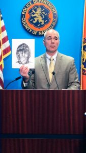 Nassau County Police Department Detective Lt. Richard LeBrun holds up a police sketch of the suspect.
