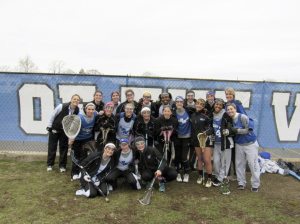 Coach Kaitlyn Carter, Kathleen Lennon and the Port Washington Girls Varsity Lacrosse team