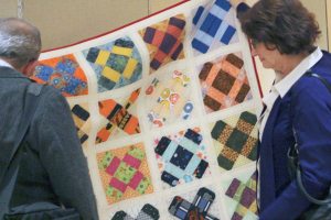 Attendees view a Mother’s Dream Quilt