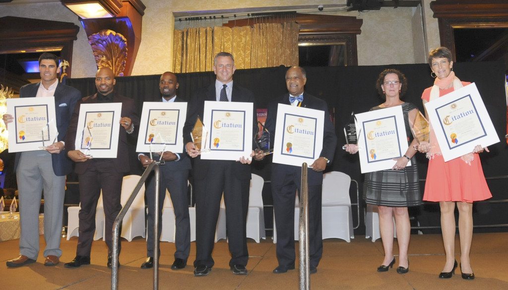 The nine athletes honored were, from left, Cold Spring Harbor High School standout baseball/basketball player Wally Szczerbiak; Morlon Greenwood of Freeport High School, who had a nine-year career in the NFL; Jason Morgan, outstanding track athlete and state champ from Lawrence High School; Ivy League “Football Player of the Year” and NFL quarterback Jay Fiedler of Oceanside High School; Rev. Ed Corley, standing in for NFL legend Jim Brown; Susan Braun, accepting for her late father Carl, a Garden City High School grad who enjoyed a long career in the NBA; and Jean Bartholomew, a dominant athlete at Garden City High School who excelled in multiple sports and played at Duke University and on the professional golf tour. (Photo by Maryola Dannebaum)