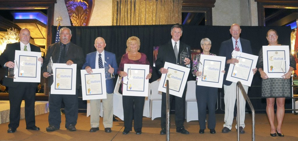 The coaches honored were, from the left, Jim Smith accepting for his father Fred, whose Locust Valley High School football teams won three county titles; Erwin Dill, accepting for longtime Bethpage coach Howie Vogts, the gridiron coach with the most wins in state football history; retired Farmingdale High School football coach Don Snyder, whose teams won well over 200 games and numerous titles; Eileen Petersen, accepting for husband Ted, who guided six Island Trees High School wrestling teams to state titles; Buddy Krumenacker, current Farmingdale High School football coach with a number of championships under his belt; Nathalie Smith, accepting for the late Lorraine “Chicky” Hoffman of the Hicksville and Massapequa districts, a pioneer in fostering women’s sports, especially lacrosse; Tom Flatley, who has compiled an .849 winning percentage guiding the Garden City High School football teams, with 18 county and five LI titles; and Diane Chapman, whose Garden City teams have compiled high winning percentages in both field hockey and lacrosse, winning six and eight state titles respectively.
