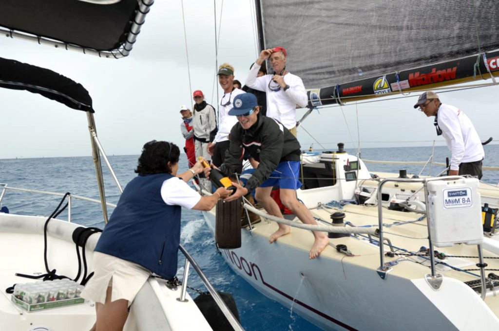2016 Newport Bermuda Yacht Race finish. HIGH NOON,  a Tripp 41 skippered by Peter Becker and crewed by 7 young sailors aged between 16 and 18. Traditional elapsed time winners. Helm: Carina Becker.Royal Bermuda YC Commodore Leatrice Oatley hands over the
