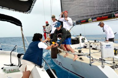 2016 Newport Bermuda Yacht Race finish. HIGH NOON,  a Tripp 41 skippered by Peter Becker and crewed by 7 young sailors aged between 16 and 18. Traditional elapsed time winners. Helm: Carina Becker.Royal Bermuda YC Commodore Leatrice Oatley hands over the