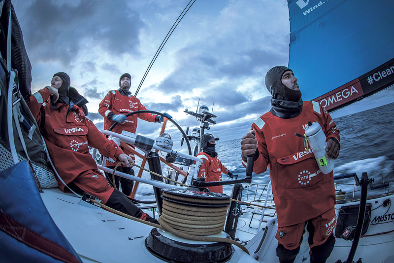 Leg 02, Lisbon to Cape Town, day 19, on board Vestas 11th Hour. Last day of sailing, Cape Town here we come. Mark Towill, Tony Mutter, Jena Mai Hansen and Charlie Enright on watch after the sunset. Photo by Martin Keruzore/Volvo Ocean Race. 23 November, 2
