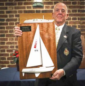 Ted Toombs holding the Herbert J. Schmidt, Jr., Memorial Race trophy. This beautiful half-model was designed and built by the master, George Huntington, who had made many beautiful half-models over the years.