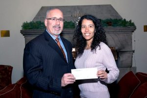 Marc Gann, Esq., a member of the Nassau County Bar Association We Care Fund, gives grant to Leila Noor, director of development for the Port Washington Parent Resource Center.