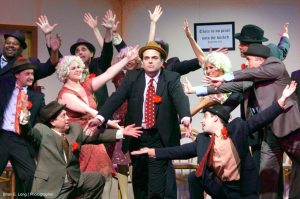 “Lucky Be a Lady” performed by Michael Santora, as Sky Masterson, and Kevin Knight and Jesse Perkins as crapshooters.