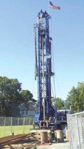 This drill rig was set up by the U.S. Navy to test for contamination in groundwater associated with the so-called Bethpage Plume. It is located at the corner of Red Maple Drive West and Wantagh Avenue in Wantagh. (Photo by Frank Rizzo)