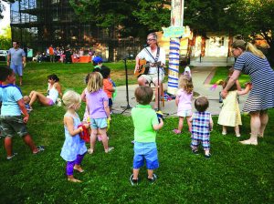 Children are moving and grooving outdoors.