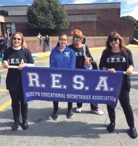 RESA members lining up before the parade through town with Roslyn High School freshman Olivia Viruet-Quintero, who came to lend her support. RESA is comprised of administrative assistants, clerk typists, secretaries and many other positions within the Roslyn School District that support the administration, faculty, staff, students and parents.