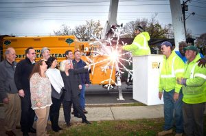 Back row: Dr. Bill Haagenson, BID board member; Middle row: Paul Oleksiw, BID president, Joe DiBartolomeo, owner Home Run Electric; front Row: Mariann Dalimonte, BID executive director, Councilwoman Dina De Giorgio, Supervisor Judi Bosworth and members of the TONH Highway Department