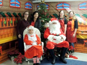 Right: Event organizers Sarah Fey, Cathy Carolan, Karen DeMerit and Kiera Walsh with Mrs. Claus and Santa (Photos by Barbara Brady Canalizo)