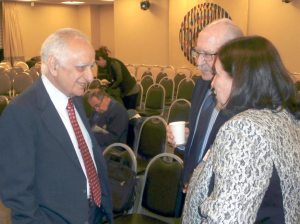 Attendees greet Khan