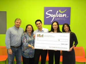 Scott Weil, board member of BID, Mariann Dalimonte, executive director of BID, Wing Ng and Lisa Yeung-Ng, owners of Sylvan Learning Center, Dina De Giorgio, councilwoman and board member of BID.