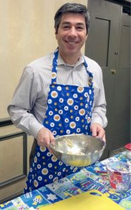 Rabbi Todd Chizner stirring up latke batter