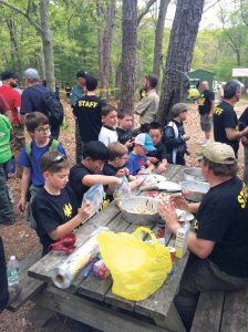 In the kitchen area, Cub Scouts were taught how to make monkey knots.