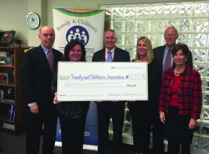 Displaying the check are (from left): Don Holden, Laureen Keenan, Dr. Jeffrey Reynolds, Yvette Wright, Dick Grafer and Gloria Grafer.